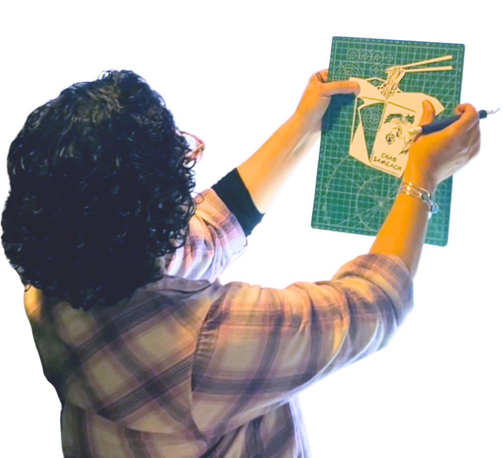 Evelyn working on a papercut art piece