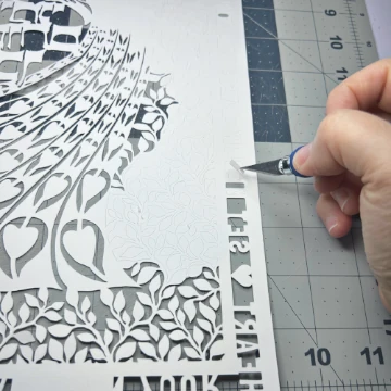 Evelyn Goldman working on her Art Nouveau peacock papercut